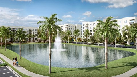 a large pond with palm trees and a fountain